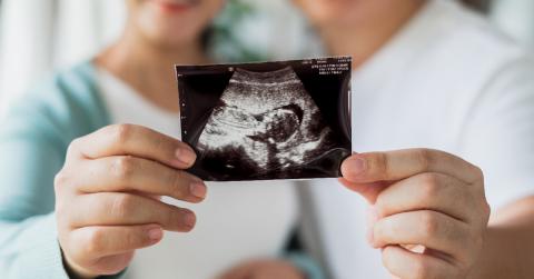 couple holding sonogram